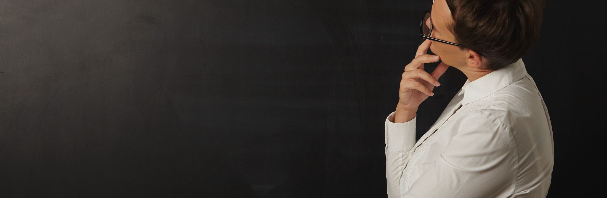 female-teacher-looking-empty-black-blackboard Banner.jpg